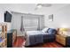 Well-lit bedroom features hardwood floors, a ceiling fan, window, and a dresser for ample storage at 1501 Clairmont Rd # 1522, Decatur, GA 30033