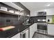 Modern kitchen features stainless steel appliances, dark countertops, and white cabinets at 1501 Clairmont Rd # 1522, Decatur, GA 30033
