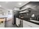 View of the modern kitchen featuring black countertops and backsplash with stainless steel appliances at 1501 Clairmont Rd # 1522, Decatur, GA 30033