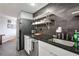 View of the modern kitchen featuring black countertops and backsplash with stainless steel appliances at 1501 Clairmont Rd # 1522, Decatur, GA 30033