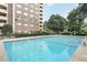 Inviting outdoor pool area with lounge area and lush landscaping surrounding the building at 1501 Clairmont Rd # 1522, Decatur, GA 30033