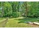 Expansive backyard with lush greenery, mature trees, and partially fenced property lines at 2210 Polar Rock Sw Ave, Atlanta, GA 30315