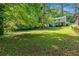View of the home's back exterior showcasing the property's spacious backyard and mature trees at 2210 Polar Rock Sw Ave, Atlanta, GA 30315
