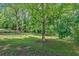 Large, partially fenced backyard with mature trees is perfect for outdoor activities at 2210 Polar Rock Sw Ave, Atlanta, GA 30315