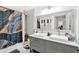 Modern bathroom with double vanity, stylish mirror, and a bathtub with unique shower curtain at 2210 Polar Rock Sw Ave, Atlanta, GA 30315