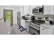 Well-lit kitchen featuring stainless steel appliances, quartz countertops, and a backyard view at 2210 Polar Rock Sw Ave, Atlanta, GA 30315