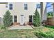 Back patio surrounded by green grass and tall evergreen trees at 3128 Onamia Rd, Duluth, GA 30096