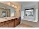Bathroom features double vanity, tub and neutral wall color at 3128 Onamia Rd, Duluth, GA 30096