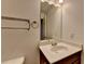 This bright bathroom features a modern vanity, a large mirror and a stainless steel towel rack at 3128 Onamia Rd, Duluth, GA 30096