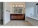 Bathroom features a double vanity and a built-in bathtub at 3128 Onamia Rd, Duluth, GA 30096