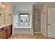 Bright bathroom features a tub with shower and double vanity at 3128 Onamia Rd, Duluth, GA 30096