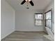 Bright bedroom features a modern ceiling fan, two large windows and hard surface flooring at 3128 Onamia Rd, Duluth, GA 30096