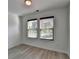 Bright bedroom features two windows, hardwood flooring, and neutral paint at 3128 Onamia Rd, Duluth, GA 30096