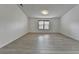 An empty bedroom featuring hardwood floors and a bright white paint, with a window at 3128 Onamia Rd, Duluth, GA 30096