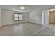 An empty bedroom featuring hardwood floors and a bright white paint, with a window and a door at 3128 Onamia Rd, Duluth, GA 30096