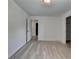 An empty bedroom featuring hardwood floors and a bright white paint, with a door to another room at 3128 Onamia Rd, Duluth, GA 30096