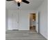 Bright bedroom features hard surface flooring, ceiling fan, and easy access to other rooms at 3128 Onamia Rd, Duluth, GA 30096