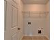 A linen closet features a wire shelf, washer and dryer hookups, and ceramic tiled floor at 3128 Onamia Rd, Duluth, GA 30096