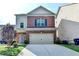 Inviting two-story home featuring a well-manicured lawn and a convenient two-car garage at 3128 Onamia Rd, Duluth, GA 30096
