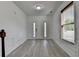 Bright foyer features stylish gray-toned hardwood flooring and classic wainscoting at 3128 Onamia Rd, Duluth, GA 30096