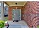Charming brick front porch with decorative touches and a secure screen door entrance at 3128 Onamia Rd, Duluth, GA 30096