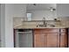 Close-up of kitchen featuring stainless steel dishwasher and sink and granite countertops at 3128 Onamia Rd, Duluth, GA 30096