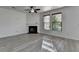 Bright living room featuring a fireplace, neutral walls, and gray wood flooring at 3128 Onamia Rd, Duluth, GA 30096