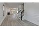 Open-concept living room features elegant hardwood floors, a fireplace, and staircase at 3128 Onamia Rd, Duluth, GA 30096