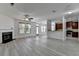 Spacious living room open to the kitchen, featuring a cozy fireplace and ample natural light at 3128 Onamia Rd, Duluth, GA 30096