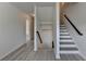 Stairway landing with gray and white stairs and a dark railing at 3128 Onamia Rd, Duluth, GA 30096