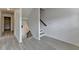 Open stairway with gray and white steps leading to the basement and upper floors at 3128 Onamia Rd, Duluth, GA 30096
