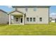 Well-maintained backyard featuring neutral siding, a porch, and a lush green lawn at 6905 Winchester Pl, Fairburn, GA 30213