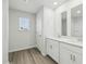Bright bathroom features a double sink vanity with ample storage and a window for natural light at 6905 Winchester Pl, Fairburn, GA 30213