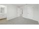Spacious bedroom featuring neutral carpet with an ensuite bathroom and closet at 6905 Winchester Pl, Fairburn, GA 30213