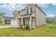 A charming two-story home, with a well-maintained lawn, features a brick facade, and a two-car garage at 6905 Winchester Pl, Fairburn, GA 30213