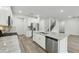 Open-concept kitchen featuring granite countertops, stainless steel appliances and easy access to the stairs at 6905 Winchester Pl, Fairburn, GA 30213
