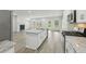 Open concept kitchen featuring granite countertops, stainless steel appliances, and a view to the living room with fireplace at 6905 Winchester Pl, Fairburn, GA 30213