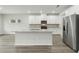 Contemporary kitchen with white cabinetry, stainless steel appliances, granite countertops, and a large island at 6905 Winchester Pl, Fairburn, GA 30213