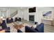 The modern living room features stylish furnishings, a fireplace, hardwood floors, and an entertainment center at 6905 Winchester Pl, Fairburn, GA 30213