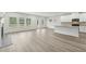 Bright open-concept living room with fireplace, many windows, and an island that connects the space to the kitchen at 6905 Winchester Pl, Fairburn, GA 30213