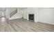 The living room features hardwood floors and a cozy fireplace, stairs, and a bright white wall at 6905 Winchester Pl, Fairburn, GA 30213