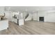 The open-concept space features hardwood floors, a center island, and a cozy fireplace at 6905 Winchester Pl, Fairburn, GA 30213