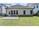 A well-maintained backyard with lush green grass, a grill, and a patio at 919 Olmsted Ln, Johns Creek, GA 30097