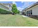 A well-maintained backyard with lush green grass, a grill, and a black fence at 919 Olmsted Ln, Johns Creek, GA 30097