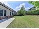 A well-maintained backyard with lush green grass, a grill, and a black fence at 919 Olmsted Ln, Johns Creek, GA 30097