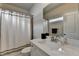 Bathroom featuring a sink with a mirror and a bathtub with a shower curtain at 919 Olmsted Ln, Johns Creek, GA 30097
