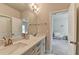 Bathroom features dual sinks, quartz countertops, and neutral cabinets at 919 Olmsted Ln, Johns Creek, GA 30097