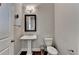 Compact powder room with pedestal sink and modern fixtures at 919 Olmsted Ln, Johns Creek, GA 30097