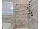 Close-up of a walk-in shower, bathtub and window that allow natural light to enter the bathroom at 919 Olmsted Ln, Johns Creek, GA 30097