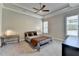 Neutral bedroom with carpet, ceiling fan, and tray ceilings at 919 Olmsted Ln, Johns Creek, GA 30097